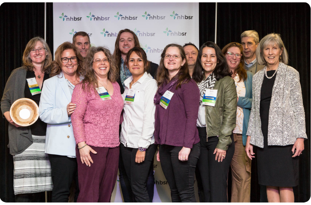 12 people standing and posing for a photo